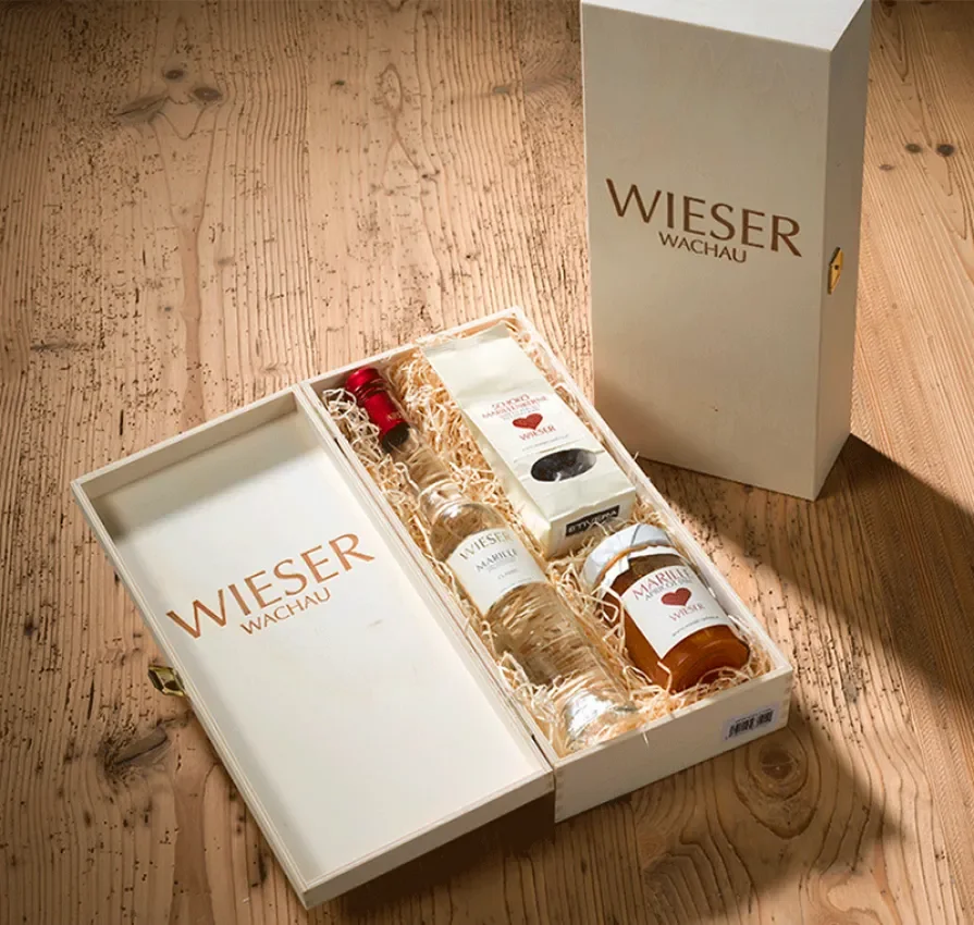 Beautiful gift box made of light wood for wine and schnapps with hinged lid.